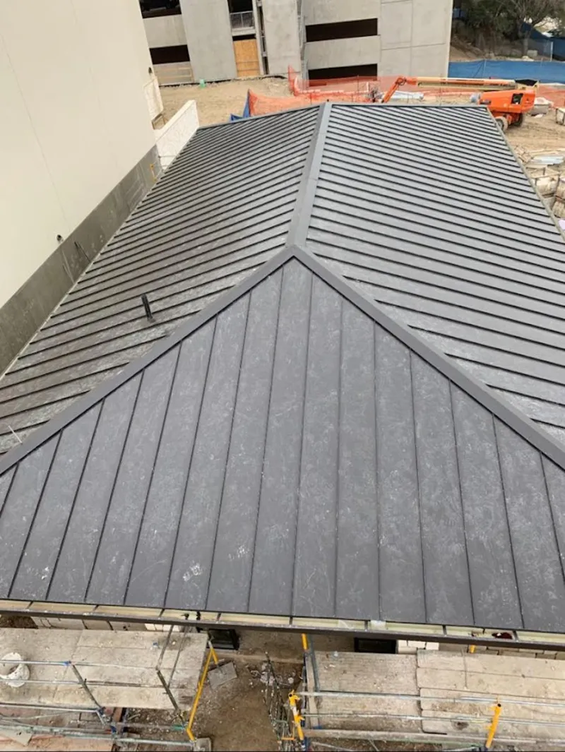 Commercial metal roof construction with crane equipment in Duanesburg