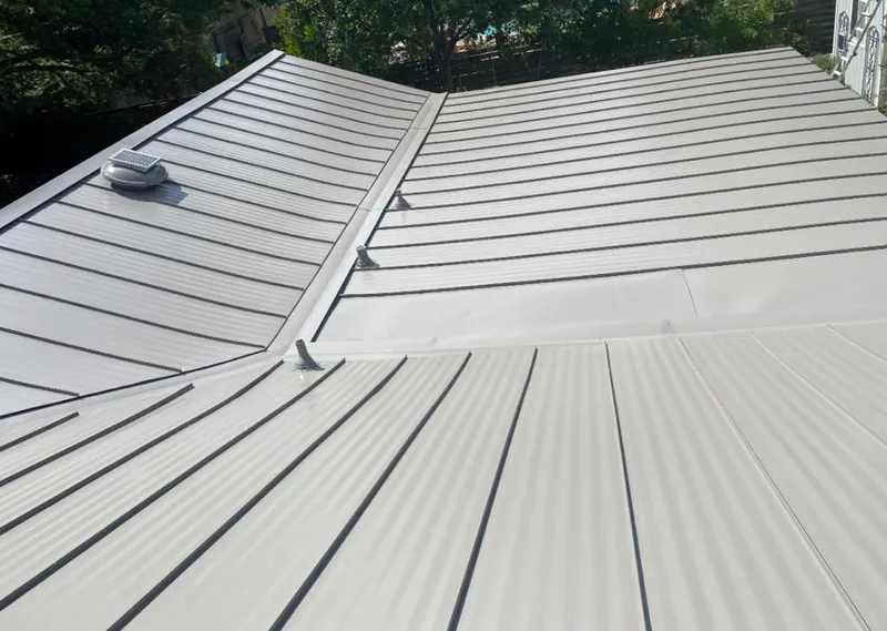 Solar attic fan installed on a metal roof for Roof Ventilation in Duanesburg